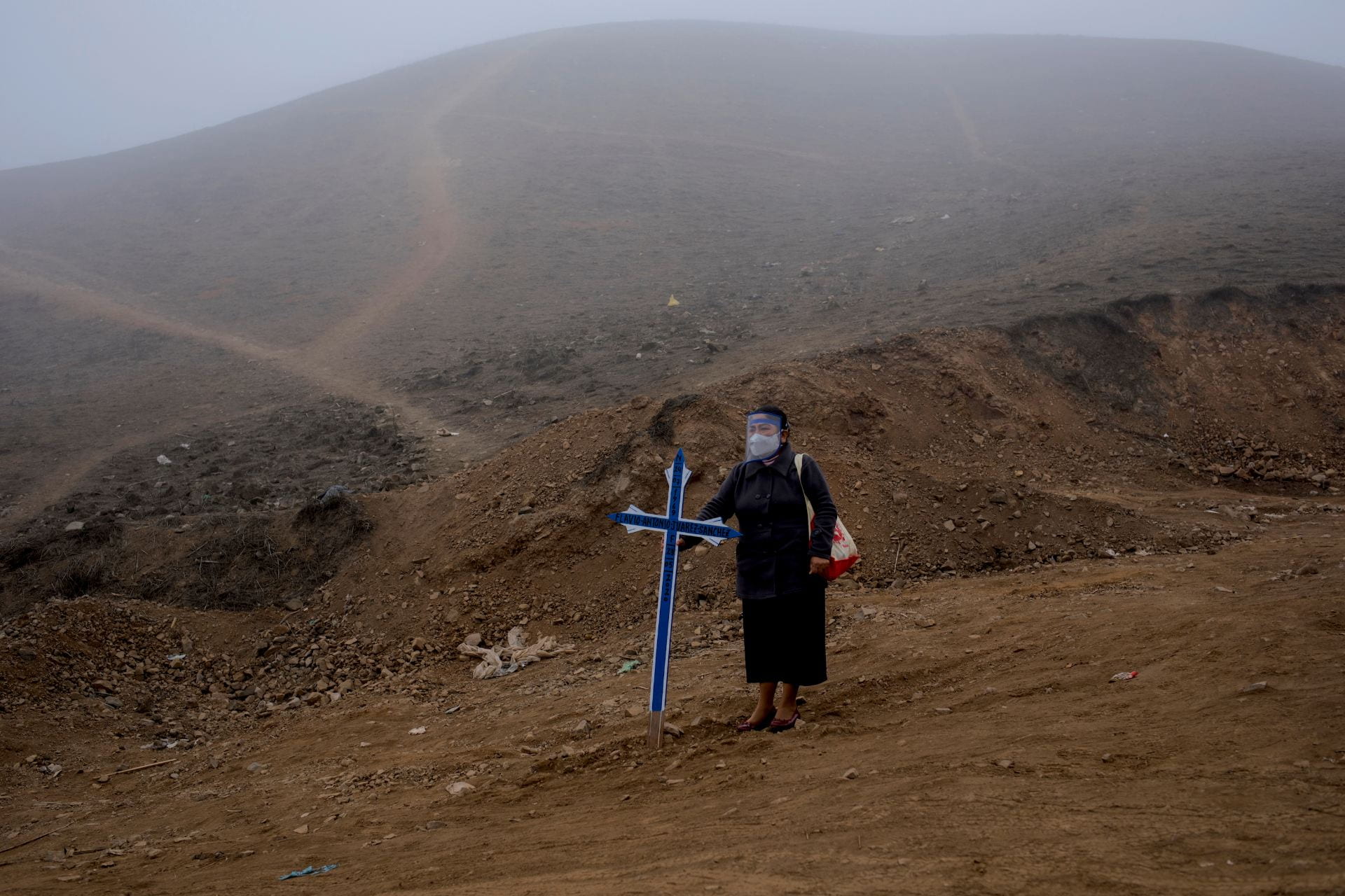 Women standing in the desert with a blue cross