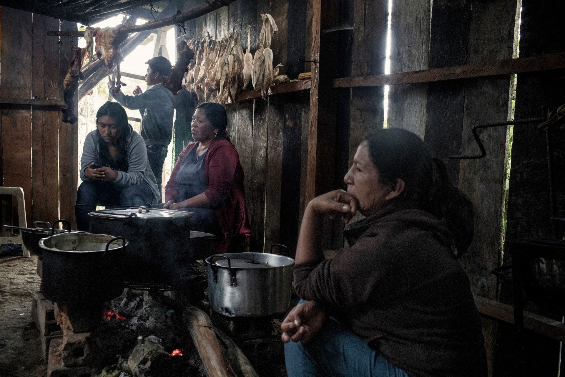 women cooking over wooden fire