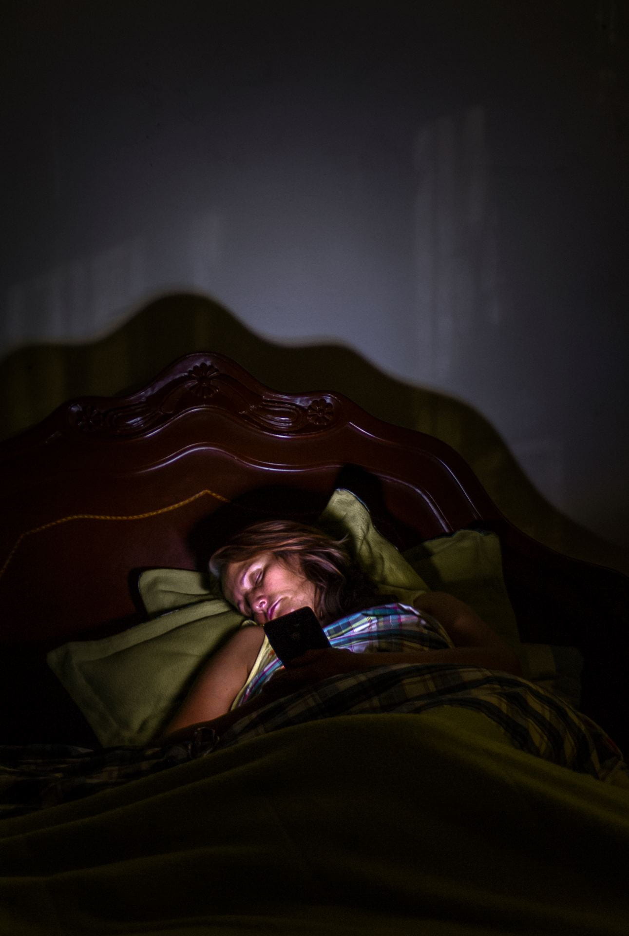 portrait of women sleeping with phone in bed
