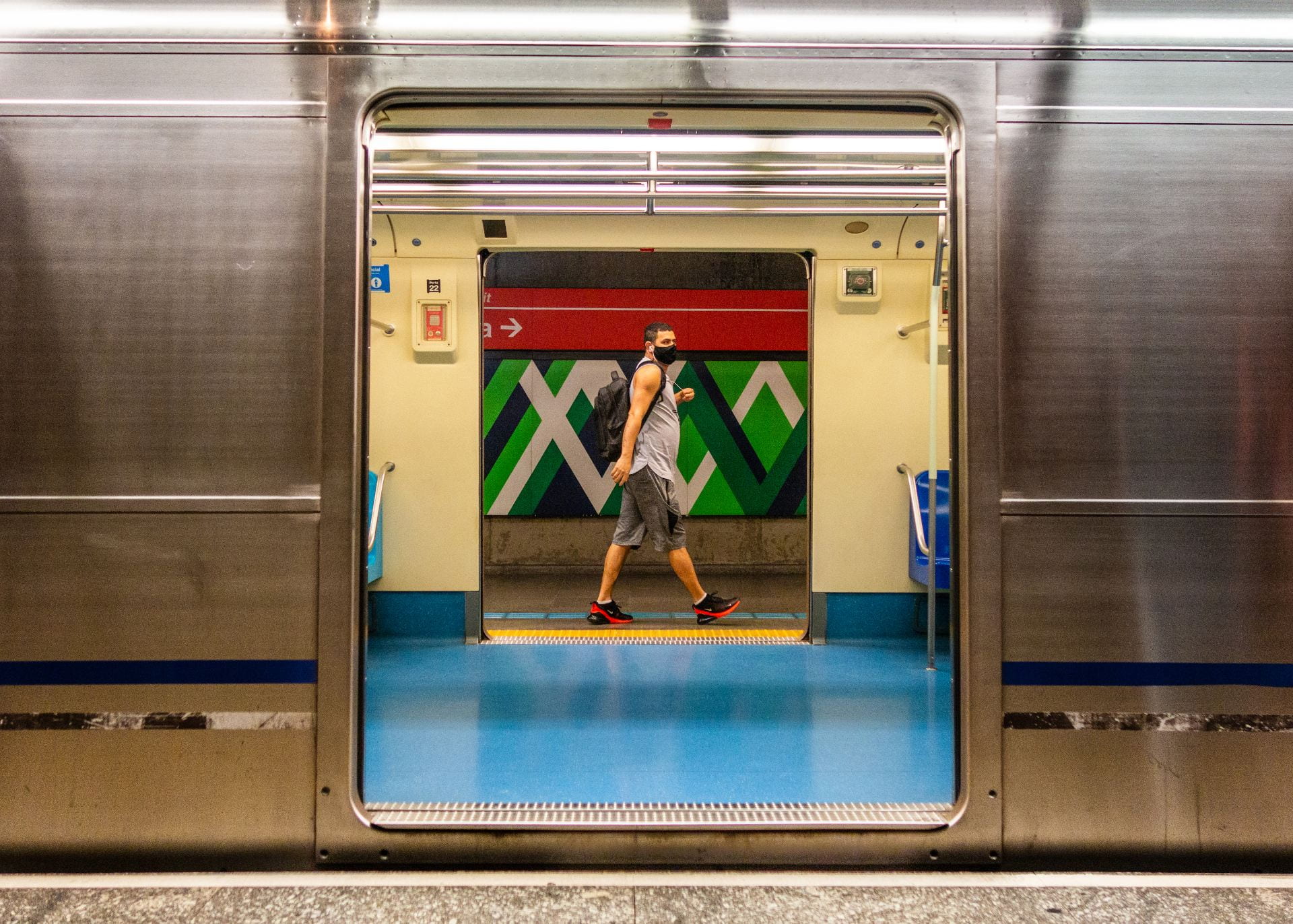 man seen through subway door
