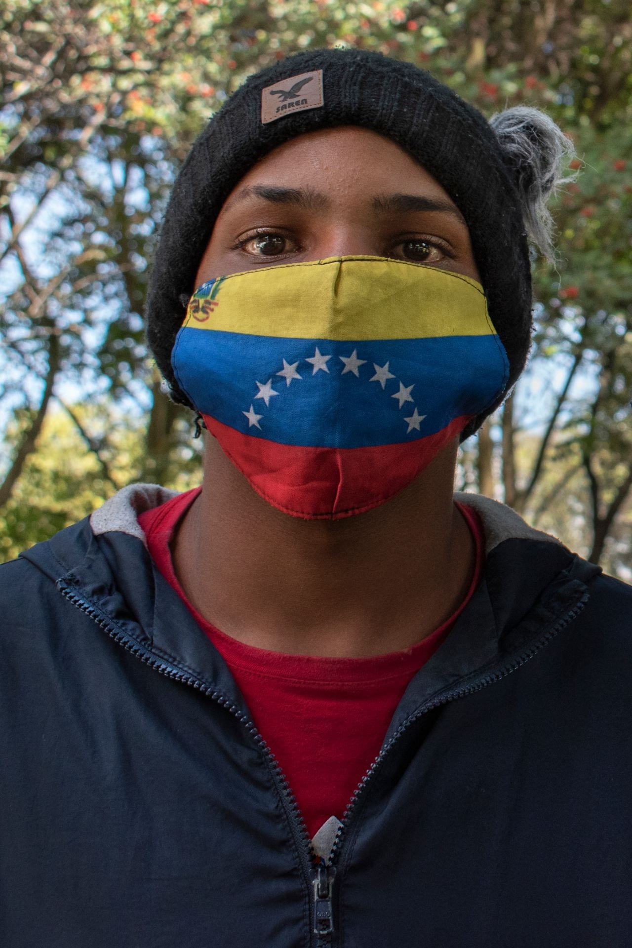 man with Venezuelan flag mask
