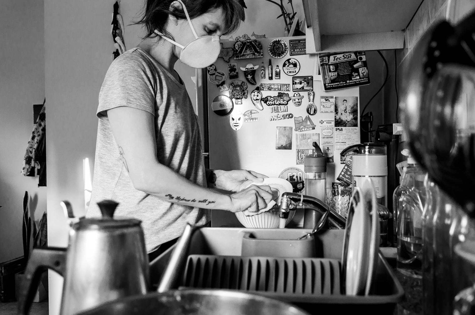 masked women washing dishes
